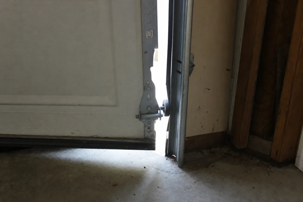 Garage door panel off its track — evidence photo taken before repair in Southlake TX